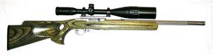 Ruger 10/22 Semi-Auto Rifle In .22 Rimfire With A Volquartsen Heavy Fluted Barrel And A Muzzle Brake And A Red-Dot Scope or an Illuminated Reticle Scope